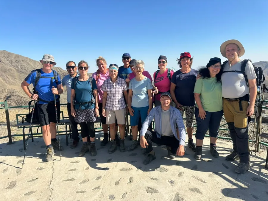A group of hikers standing together against a mountain landscape