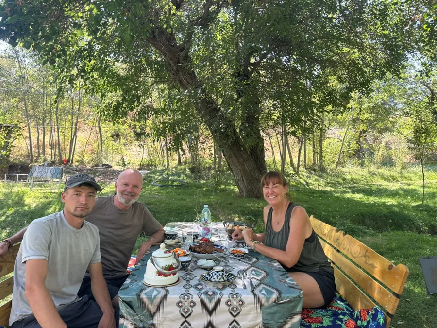Guests enjoying breakfast at a shaded garden table