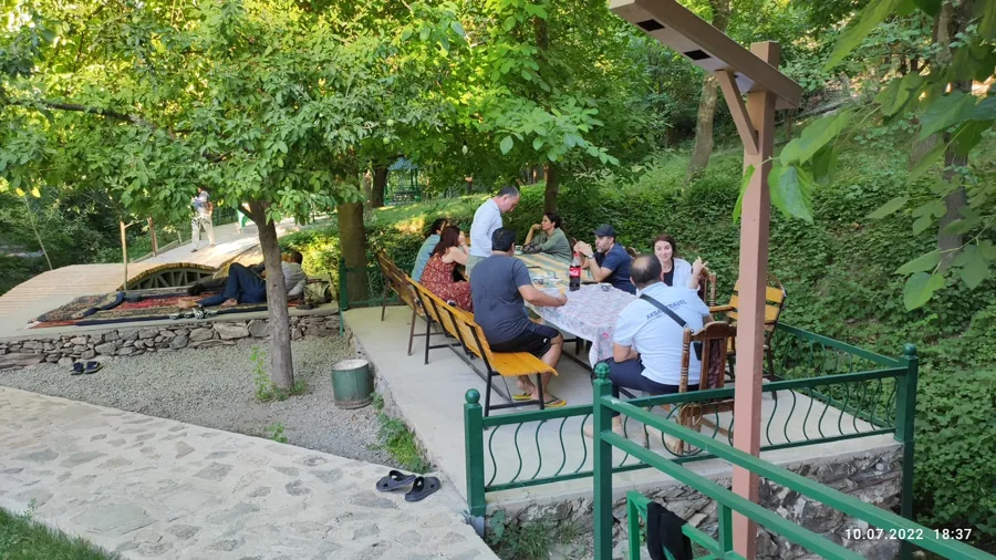 Guests relaxing in an open-sided garden pavilion