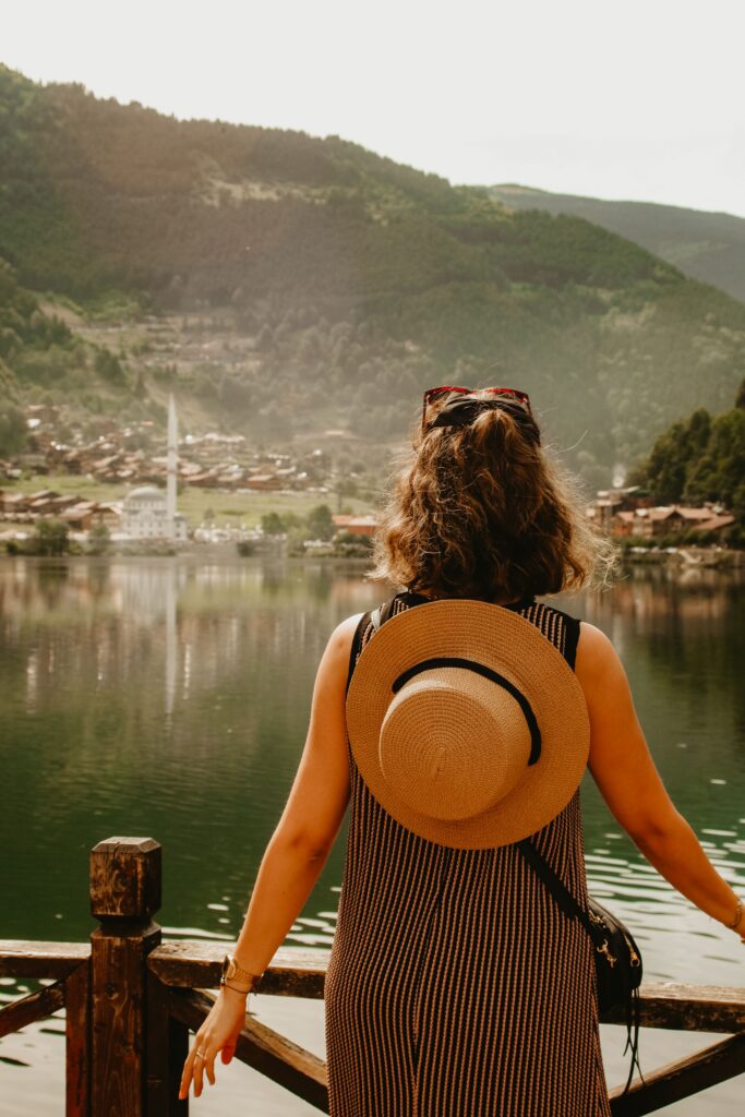 Traveler looking across a calm lakeside village