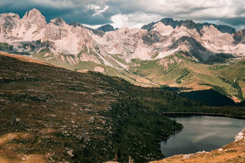 Small alpine lake beneath pale rocky peaks