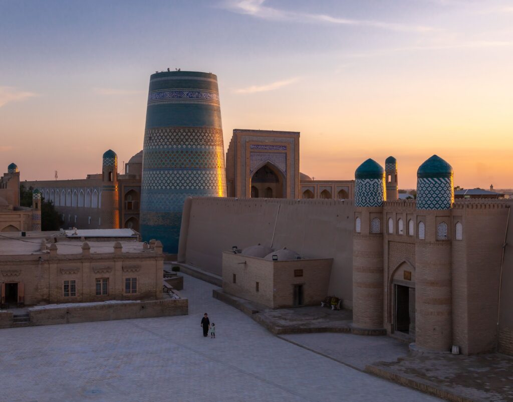 Historic minaret and domed skyline at sunset