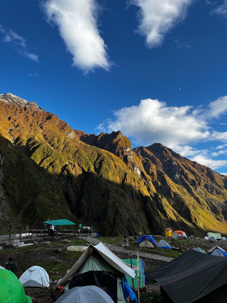 Mountain campsite beneath steep rocky peaks