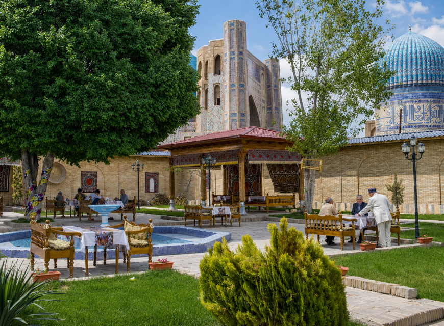 Traditional building surrounded by trees and landscaped gardens