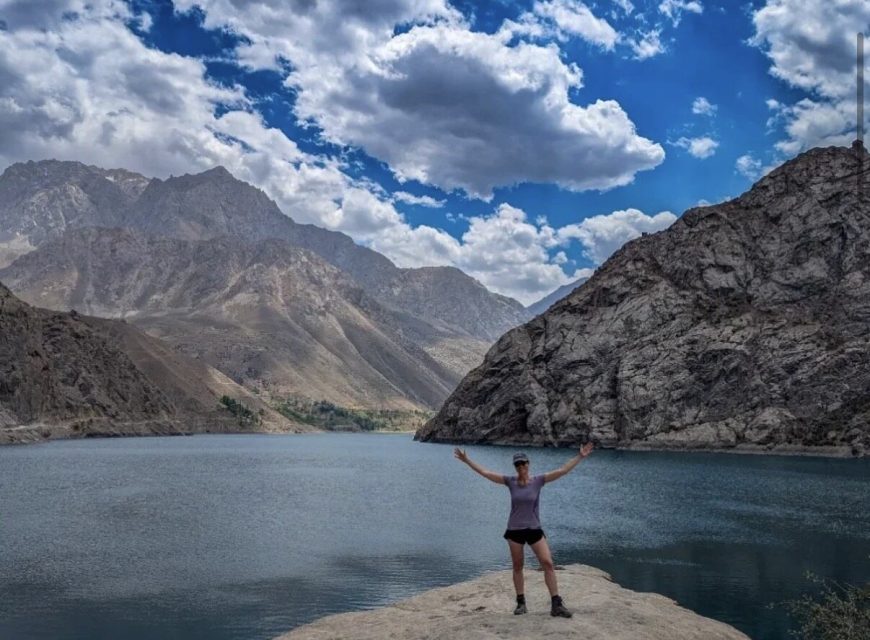 A traveler overlooking a mountain lake on the Seven Lakes route in Tajikistan.