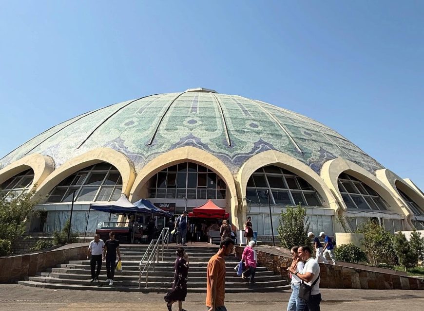 Visitors outside the blue-domed Chorsu Bazaar in Tashkent.