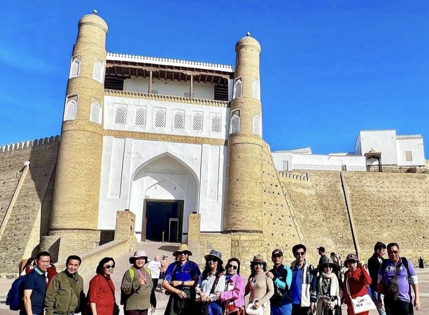 Travelers outside the entrance to the Ark fortress in Bukhara.
