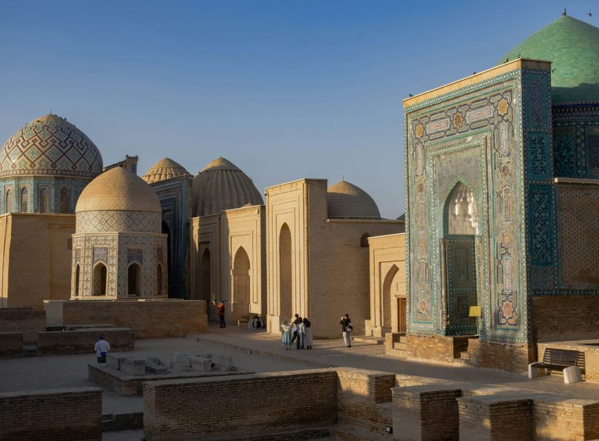 Ancient domed buildings illuminated by warm evening sunlight