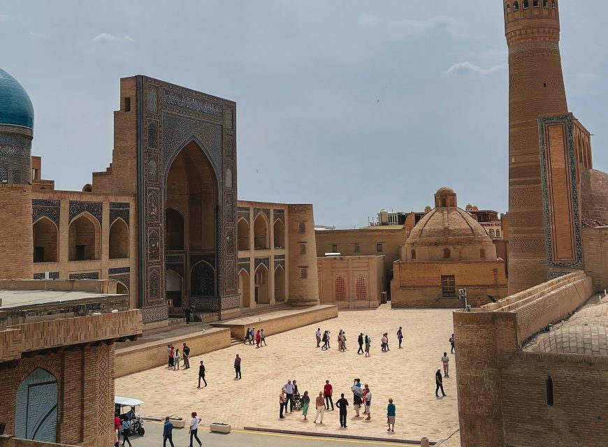 Historic madrasa courtyard with a tall brick minaret