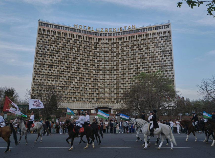 Curved modernist hotel building viewed from below