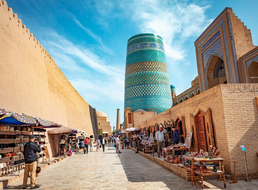 Kalta Minor minaret rising between historic buildings in Khiva