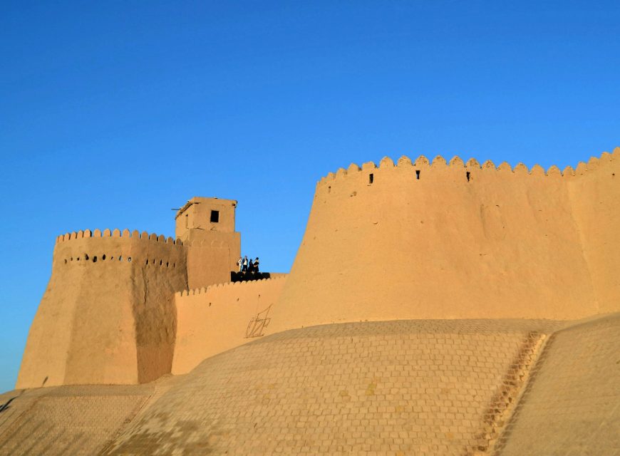 Ancient mud-brick fortress walls under a clear blue sky