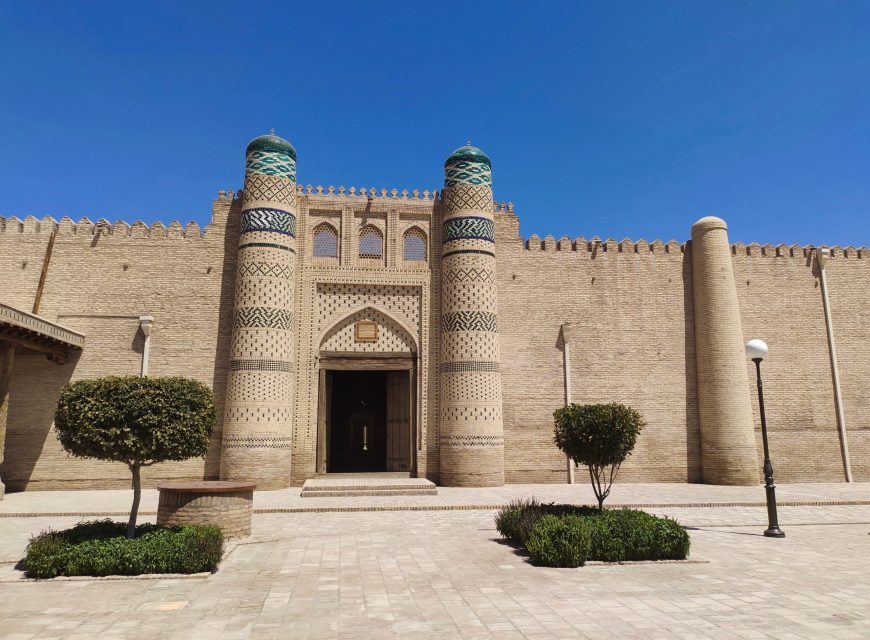 Ornate palace gate with twin mosaic towers in historic Khiva, Uzbekistan