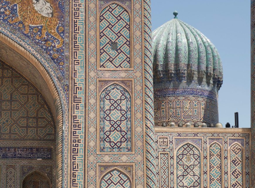Close-up of a ribbed turquoise dome and detailed geometric Islamic mosaic tilework on an ancient Silk Road monument in Samarkand, Uzbekistan.