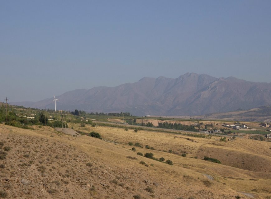Hazy mountain valley with fields and rural settlements