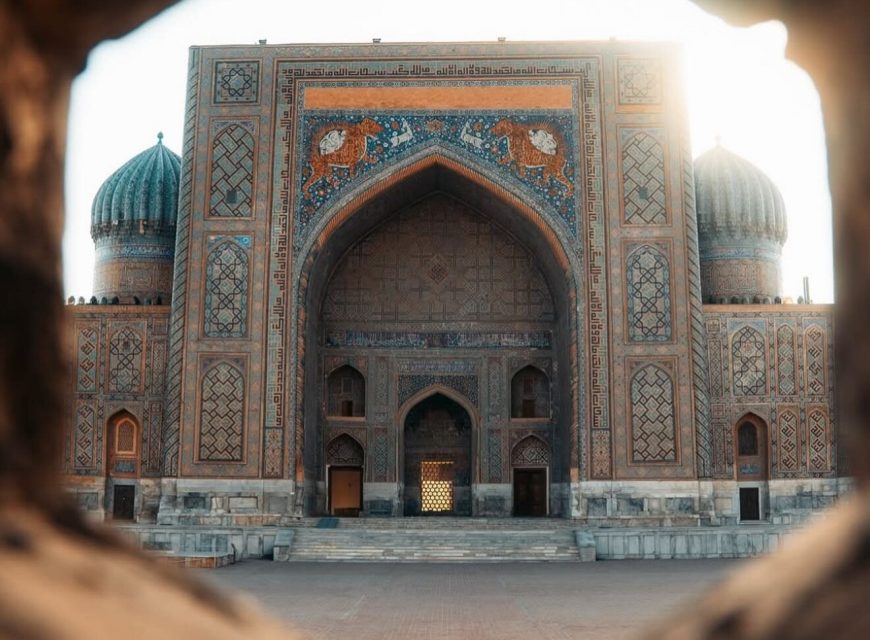 A tiled entrance and domes of a historic monument in Samarkand.